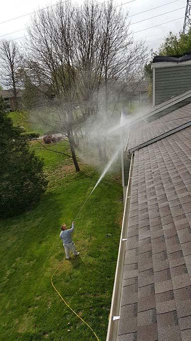 Man pressure washing a home in Nashville, TN
