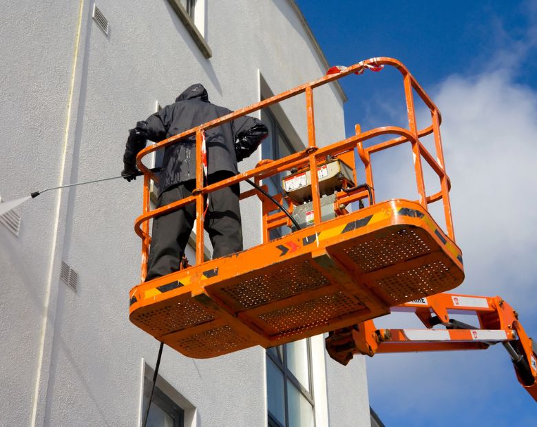 Specialist performing a commercial power washing service in Nashville, TN
